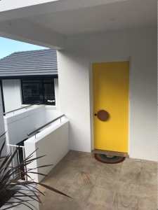 Timber entry door handle on yellow door